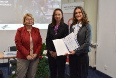 Uczestnik pozuje z dyplomem, obok pani z MSZ i dyrektor KSAP